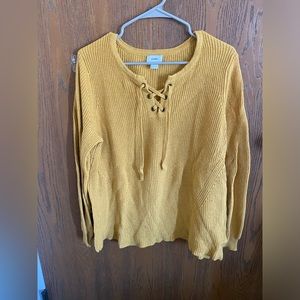 Lightly worn mustard sweater.